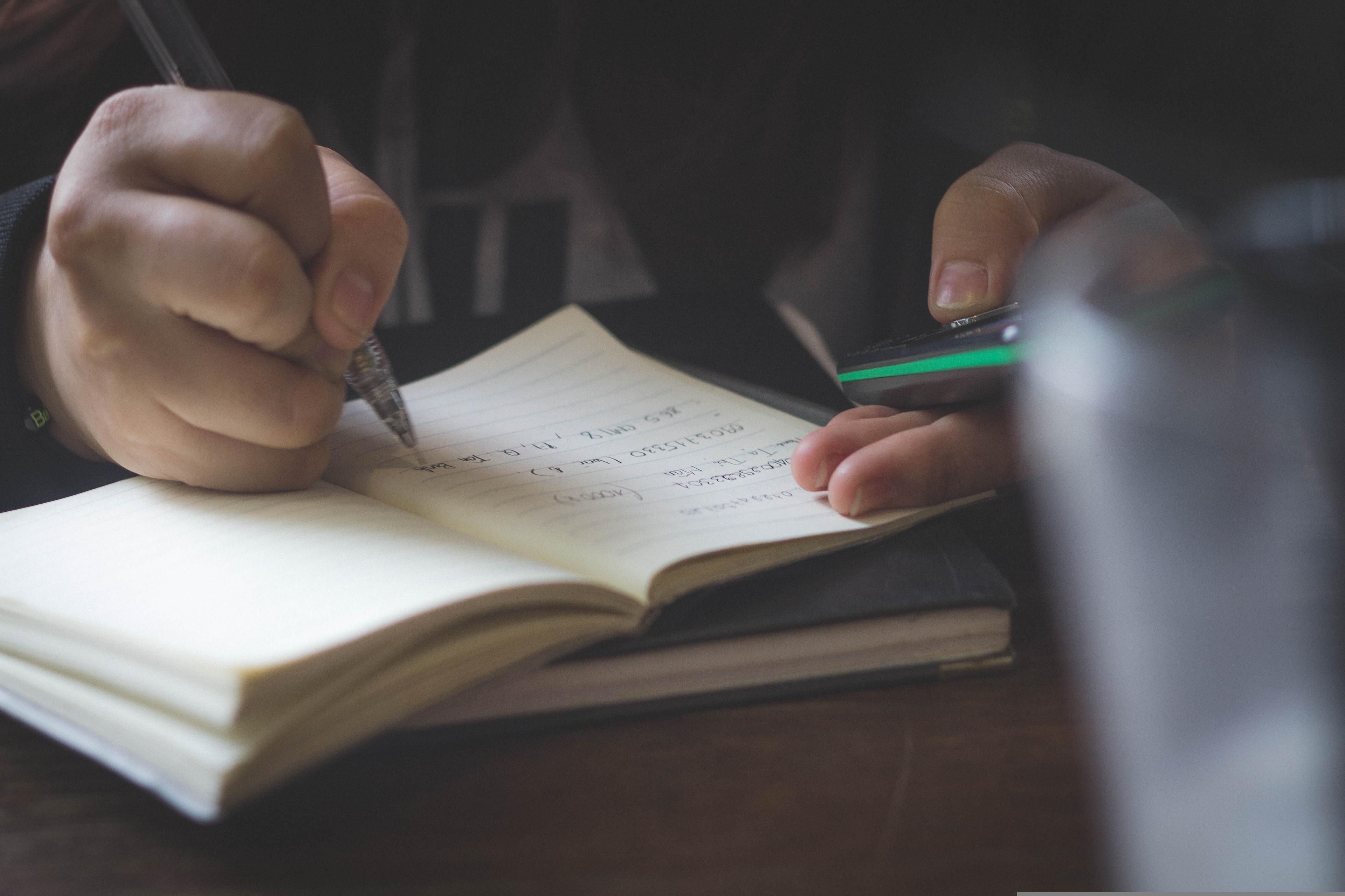 Student writing notes during academic work